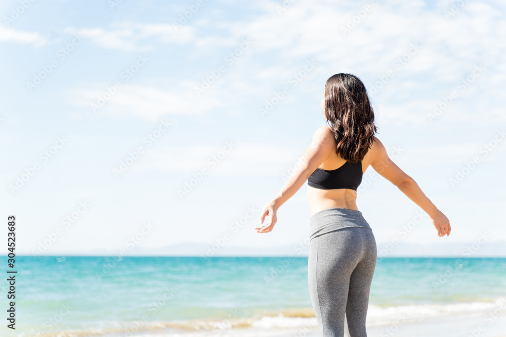 Young Athlete In Sportswear Standing At Beach Young Athlete In Sportswear Standing At Beach