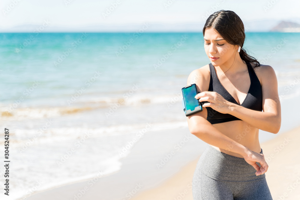 Woman Preparing Before Exercising On Beach