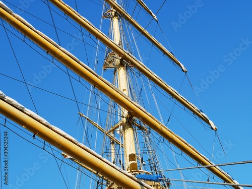 the ship's rope hangs on the mast of a sailing ship. A Bay of nylon rope on the deck of a sailboat.