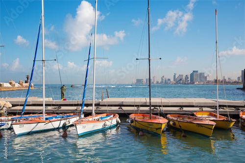 TEL AVIV, ISRAEL - MARCH 2, 2015: The little harbor and yachts under old Jaffa and Tel Aviv in the backgound in the morning light