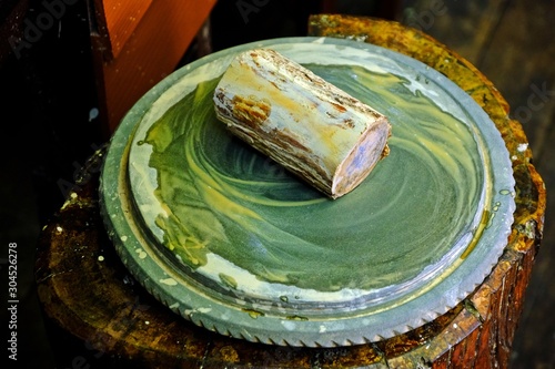 Thanaka (A yellowish-white cosmetic paste made from ground bark) on stone slab, The culture of Myanmar. photo