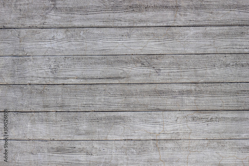 Gray concrete wall with traces of boards. Horizontal lines.