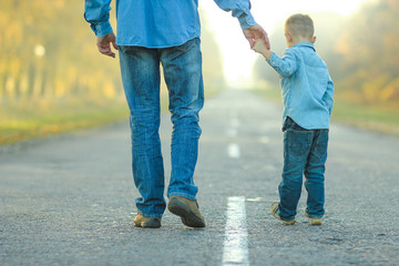 father and son walk in nature