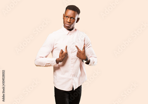 Fotografie young african american black man pointing to self with a confused and quizzical