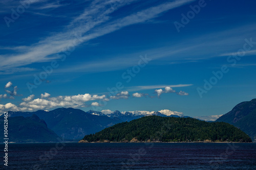 Islands and mountains adorned by silver clouds, off BC, Canada © Ravi