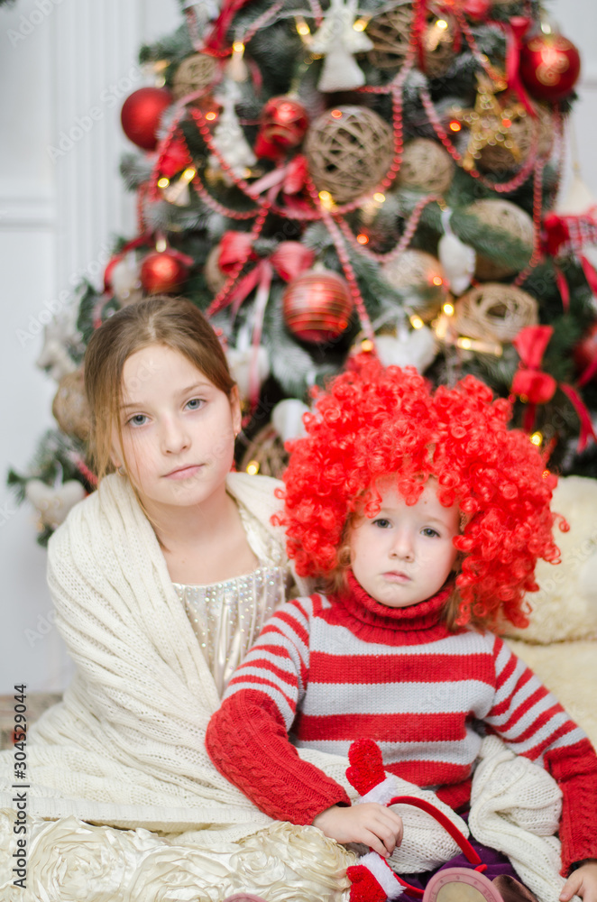 happy child girl in a Christmas hat waiting for a miracle.