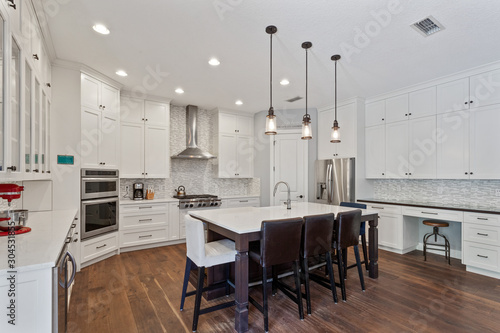 Upscale white kitchen with stainless steel appliances