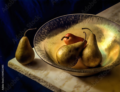 Three pears sit in a gold crackle glass bowl, creating a dramatic arc, that sits on a cream marble slab with a verigated blue velvet background  photo