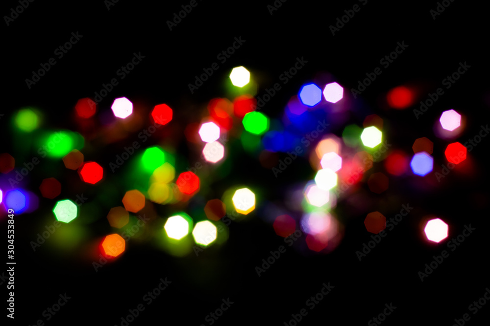 Christmas lights are lit on a black background. Copy the area for the top view text.