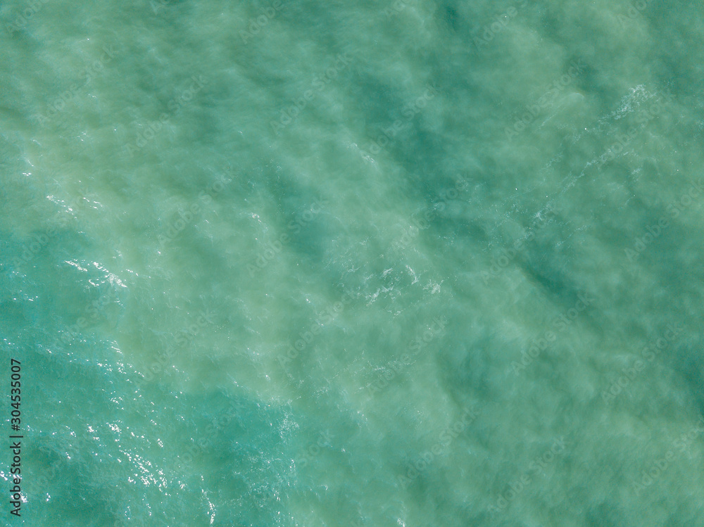 Aerial view of turquoise waves, water surface texture. Thailand