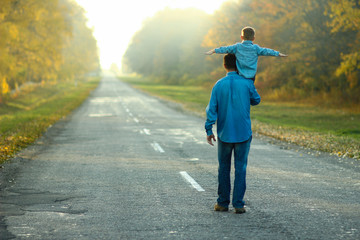 father and son walk in nature