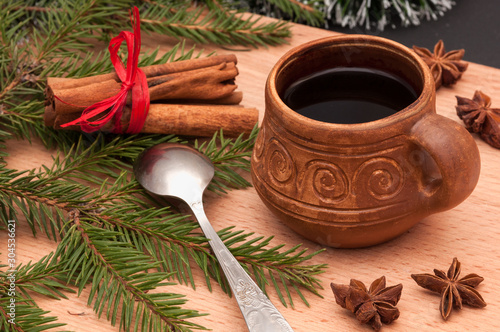 Christmas composition – cup of coffee, anise, cinnamon. On wooden background.