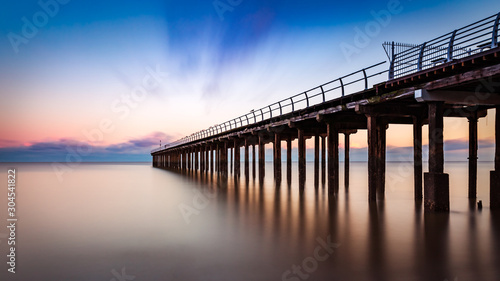 Obraz na plátně Pier at sunrise