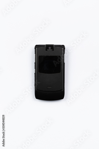 Photo of a used classic mobile phone, top view on white paperPhoto of a used classic mobile phone, top view on white background