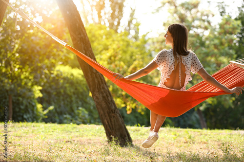 Happy young woman sitting i...