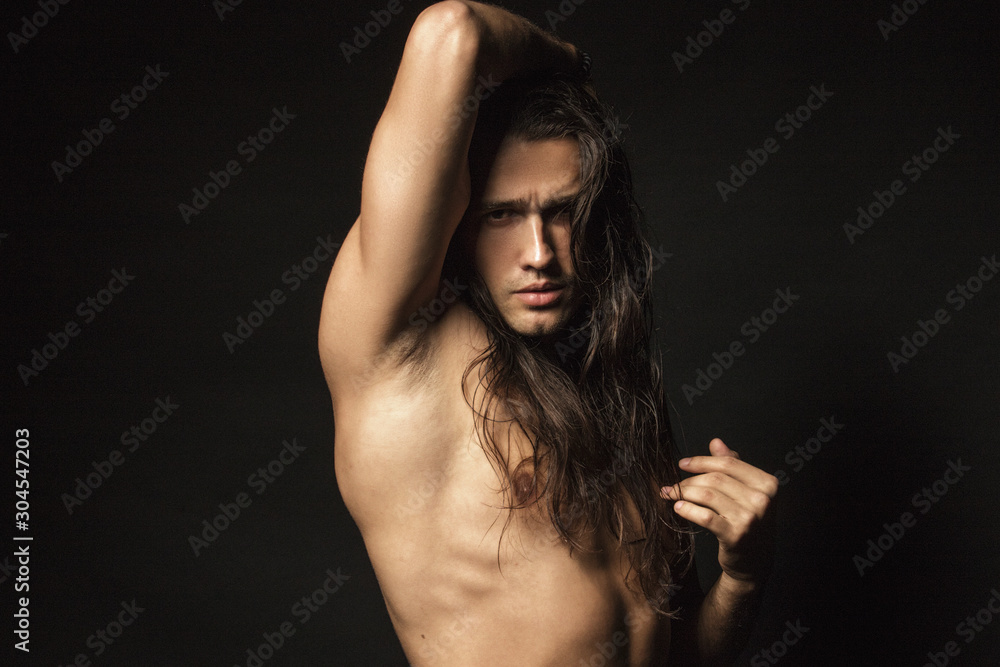 Handsome sport masculed sexy stripped guy with white towel on isolated black background font Handsome sport masculed sexy stripped guy with white towel on isolated black background font