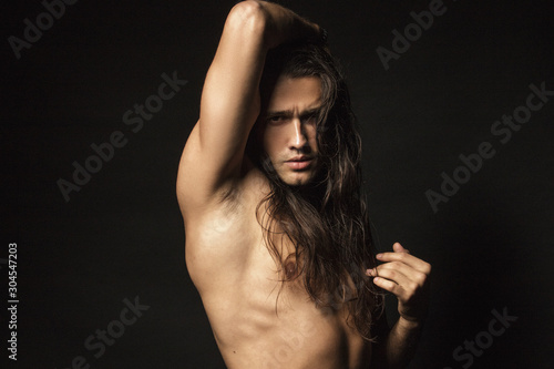 Handsome sport masculed sexy stripped guy with white towel on isolated black background font