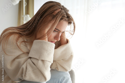 Portrait of depressed woman at home photo