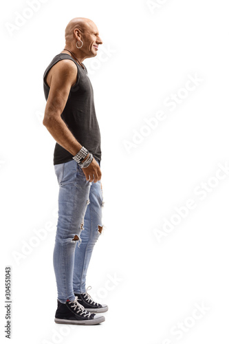Bald male middle-aged hipster wearing ripped jeans