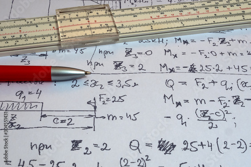Tableau sur toile Vintage antique slide rule, logarithmic scale, calculations on paper,  and pen