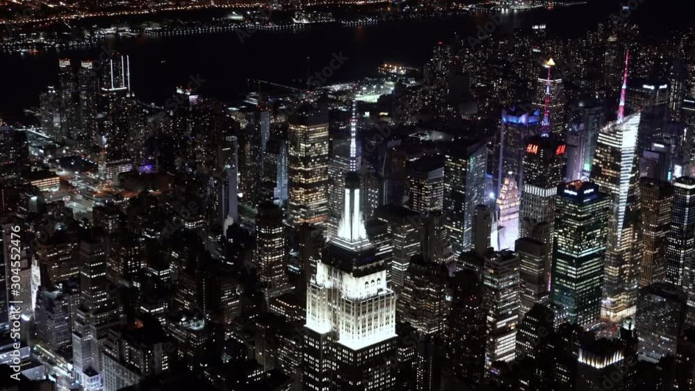 4K Aerial Sequence of New York City , USA - close-up view of the Empire State Building at Night as seen from a helicopter