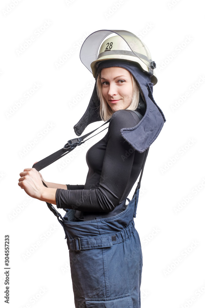 Young beauty firewoman pulls suspenders on her pants, smiling and looking to the camera Young beauty firewoman pulls suspenders on her pants, smiling and looking to the camera