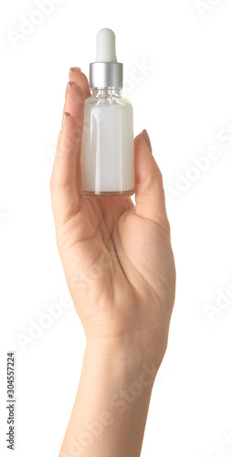 Female hand with cosmetic product in bottle on white background