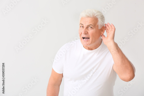 Mature man with hearing pro...