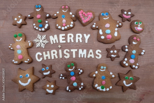 Merry Christmas message with wooden letters and homemade gingerbread cookies
