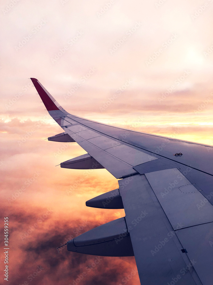 Fototapeta premium Clouds and sky through window of an airplane.
