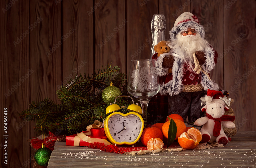 The clock, Santa Claus, spruce branchs, tangerines, and champagne