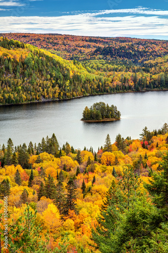 Autumn Forest Lake Landscape with a little Pine Island in La Mauricie National Park, Province of Quebec, Canada.