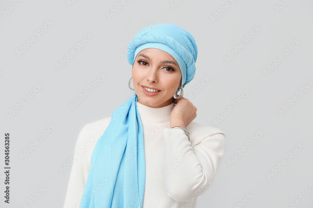 Portrait of beautiful Muslim woman on light background Portrait of beautiful Muslim woman on light background