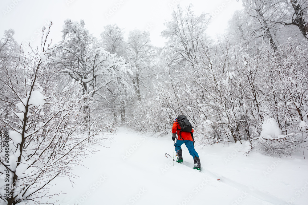 A skier is walking up the hill.