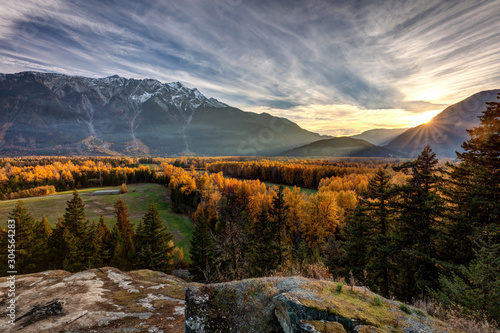 The sunshine giving a golden glow to the trees in Autumn with Mount Currie towering over the Pemberton Valley in British Columbia, Canada photo