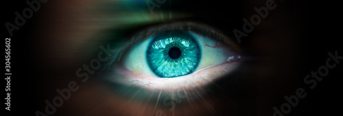 Future eye concept. Close up of a man's eye. Radial blur as a concept of movement. Banner with a dark background and an eye inside.