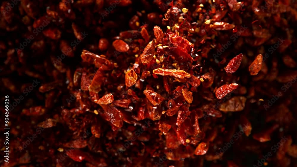 Super slow motion of flying dry red hot chilli peppers. Filmed on high speed camera, 1000 fps Super slow motion of flying dry red hot chilli peppers. Filmed on high speed camera, 1000 fps