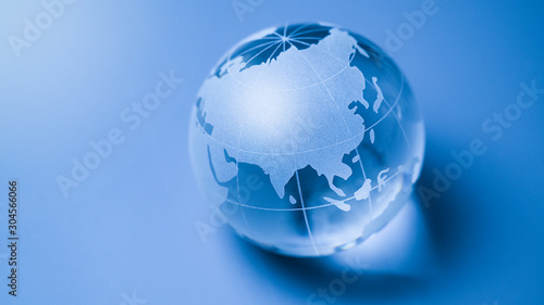 World business finance glass globe map earth ball on blue background with continents focus china, india and russia a symbol for asia economy with copyspace.