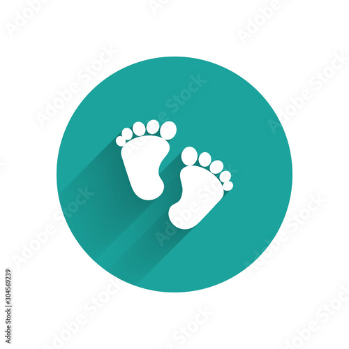 White Baby footprints icon isolated with long shadow. Baby feet sign. Green circle button. Vector Illustration