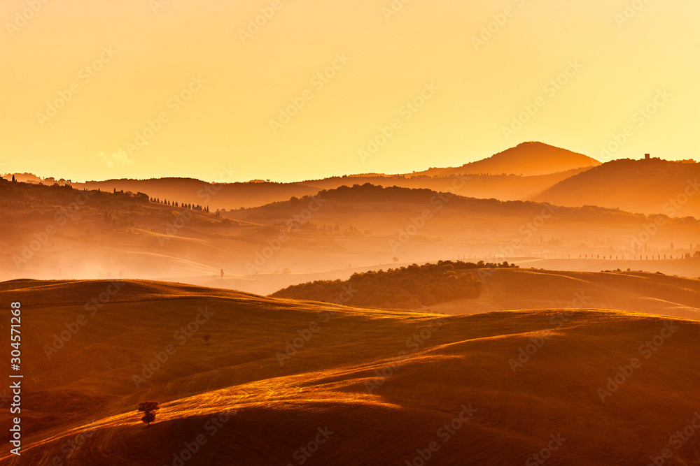 Tuscan hills at sunrise. Typical rural landscape. Tuscany, Italy