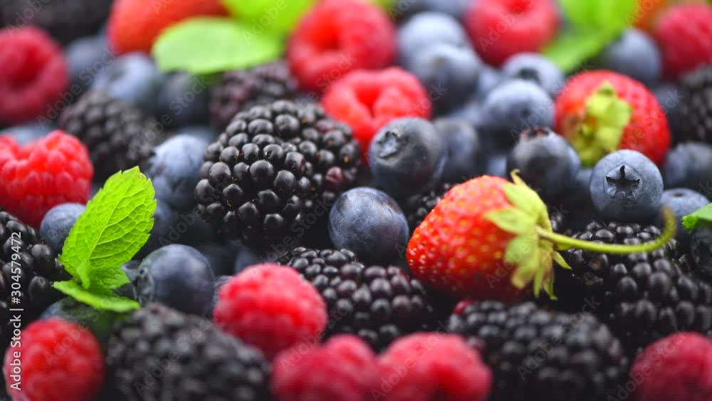 Berries. Various colorful berries background. Strawberry, raspberry, blackberry, blueberry closeup over black. Healthy eating. Rotation. Slow motion 4K UHD video footage. 3840X2160 Berries. Various colorful berries background. Strawberry, raspberry, blackberry, blueberry closeup over black. Healthy eating. Rotation. Slow motion 4K UHD video footage. 3840X2160