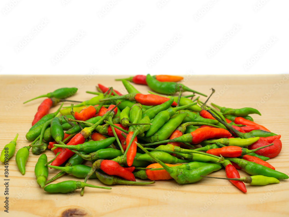 Red and Green hot chilli on a wooden floor. Red and Green hot chilli on a wooden floor.
