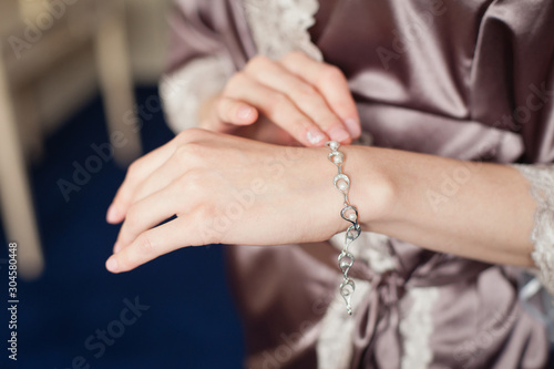 Woman's hands with perfect manicure with silver bracelet