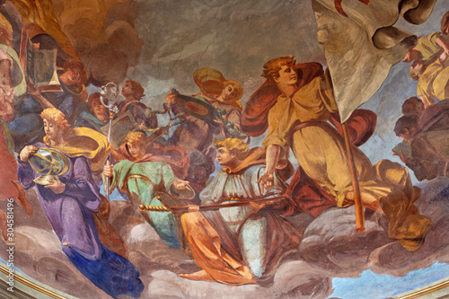 REGGIO EMILIA, ITALY - APRIL 12, 2018: The Fresco of angels with the symbols in cupola of church Basilica di San Prospero by  C. Manicardi, G. Ferrari and A. Lugli (1884-1885).
