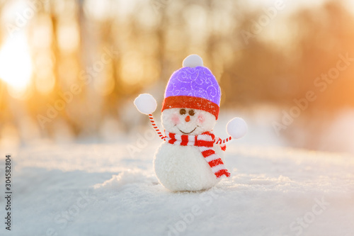 Snowman in winter wonderland scene. Christmas, New Year postcard design. Wintertime magic. Snowman in december snow at sunset © Miramiska