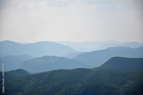 View of multiple levels of moutains from the top of the Acrople des Draveurs trail at the Hautes-Gorges-de-la-Rivière-Malbaie National Park (SEPAQ), Charlevoix Region, Quebec, Canada photo