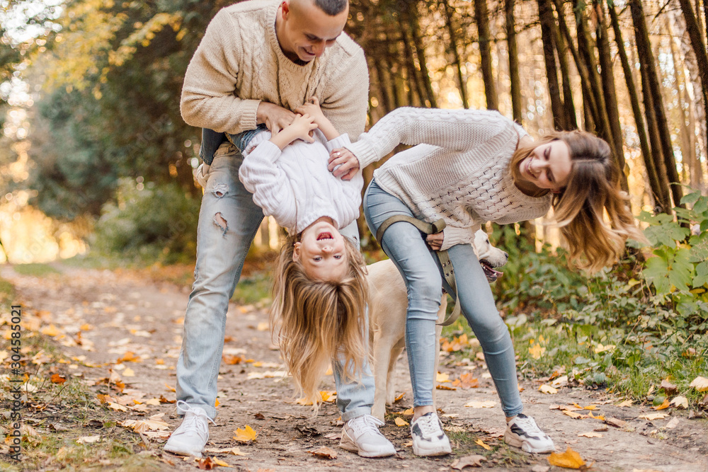 Fototapeta premium Happy family is having fun walking in the park.