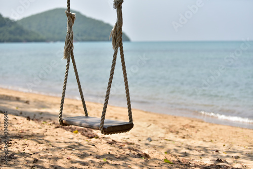 Wooden swing by the sea, guiet atmosphere, photo