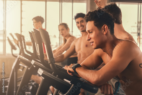 group of people having workout with treadmill running machine in gym or fitness center