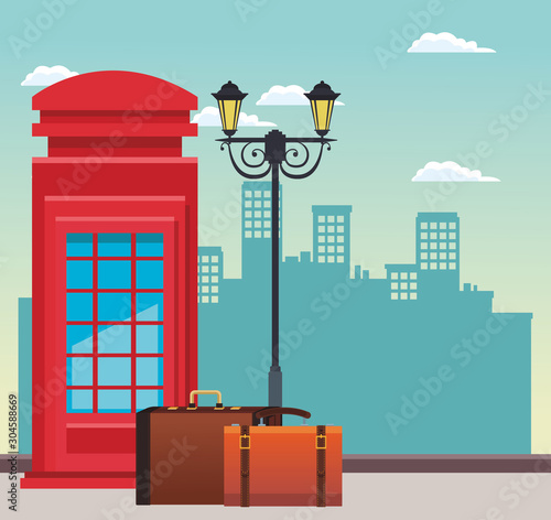 red telephone box and street lamp with travel suitcases over urban city buildings scenary background